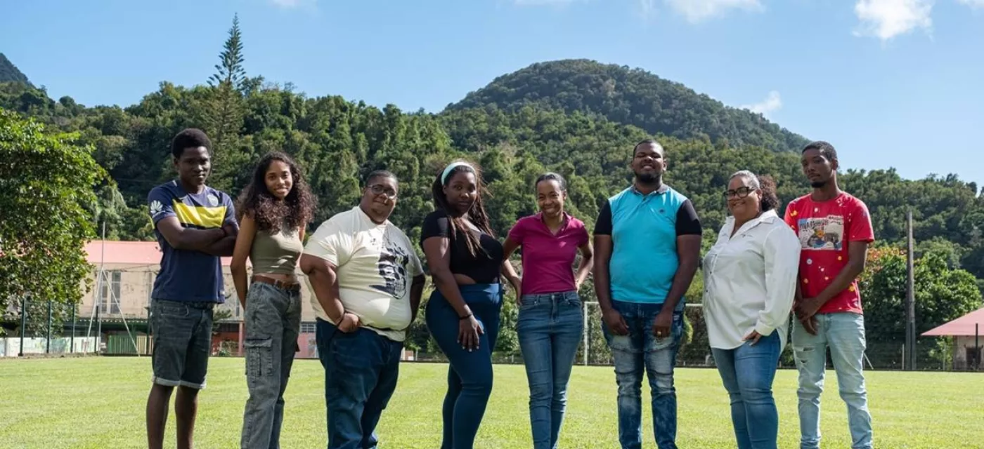 Un groupe de jeunes de face sur un terrain de foot en extérieur